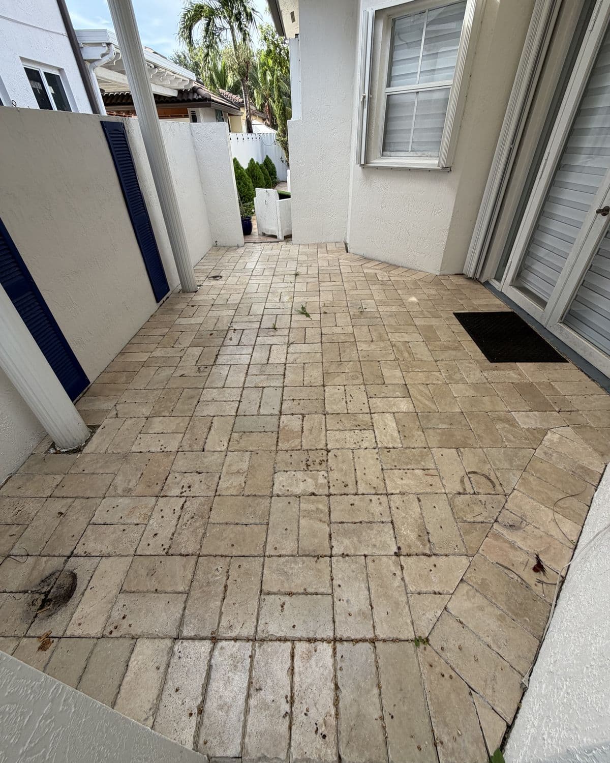 Travertine side patio in South Florida — before cleaning